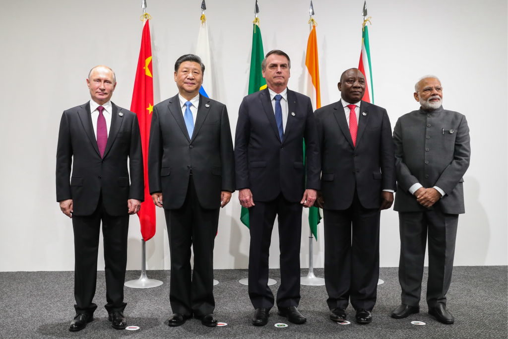 Russia's President Vladimir Putin, China's President Xi Jinping, Brazil's President Jair Bolsonaro, South Africa's President Cyril Ramaphosa and India's Prime Minister Narendra Modi (L-R) pose for a BRICS meeting on the sidelines of the 2019 G20 Summit at the INTEX Osaka International Exhibition Centre. Mikhail Klimentyev/Russian Presidential Press and Information Office/TASS (Photo by Mikhail KlimentyevTASS via Getty Images)