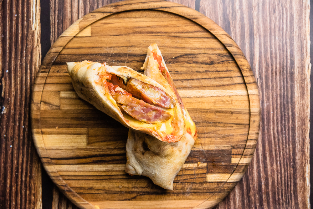 Pizza e sanduíche com a deliciosa linguiça caipira são as novidades do mês na Grano & Oliva e Inforno Burger